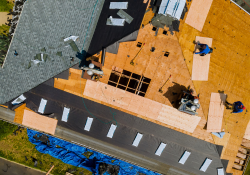 Aerial view of a roof installation in progress in Oklahoma City, highlighting professional roofing services by Warrior Roofing Solutions.