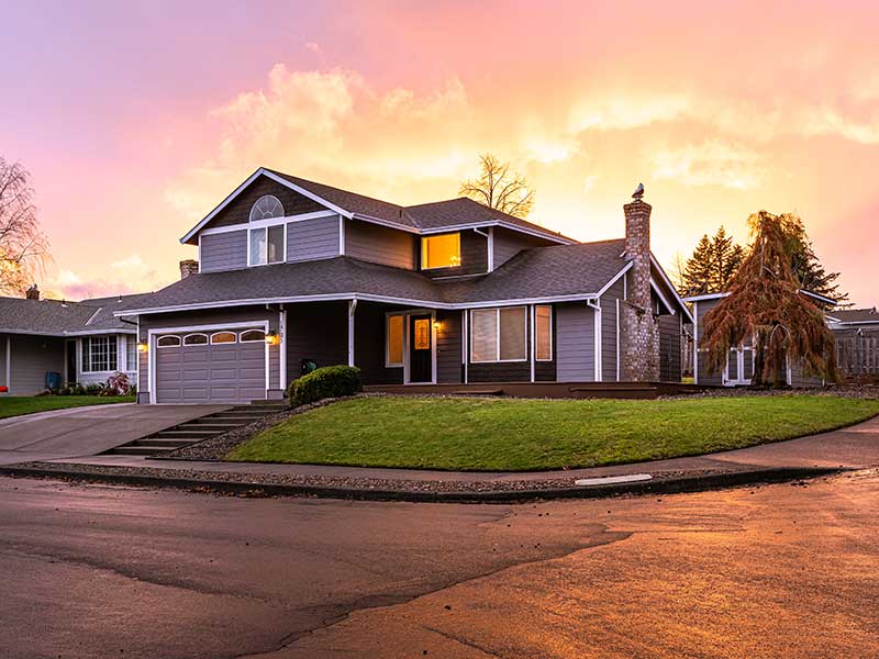 Modern, mid-class corner home during a sunset