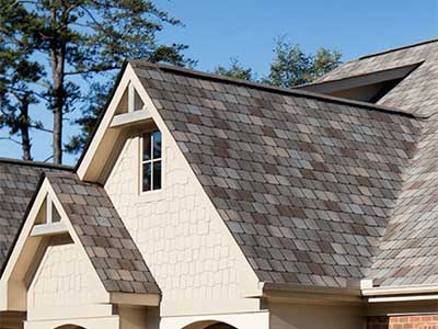 Close up of a residential roof with Atlas shingles, each a different variety of brown